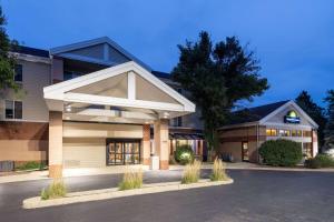 a building with a parking lot in front of it at Days Inn & Suites by Wyndham Madison in Madison