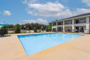 a large swimming pool in front of a building at Days Inn by Wyndham Spartanburg Waccamaw in Southern Shops