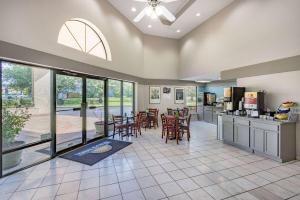 a kitchen and dining room with a table and chairs at Days Inn by Wyndham Spartanburg Waccamaw in Southern Shops