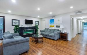 a living room with two couches and a fireplace at Days Inn by Wyndham Savannah in Savannah