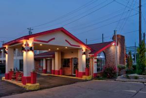 a red and white building with lights on it at Super 8 by Wyndham Vernon in Vernon