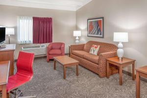 a living room with a couch and a chair at Ramada by Wyndham Hammond Hotel & Conference Center in Hammond