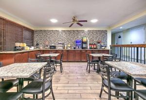 a restaurant with tables and chairs and a counter at Days Inn by Wyndham Greenville MS in Greenville