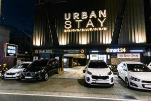 a group of cars parked in front of a car dealership at Urban Stay in Cheonan