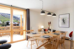 - une salle à manger avec une table et des chaises en bois dans l'établissement Résidence Neige et Soleil by Leavetown Vacations, à Les Deux Alpes