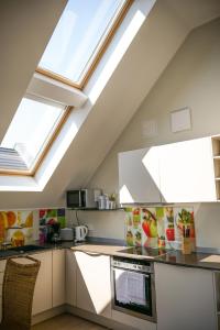 a kitchen with skylights in the ceiling of a attic at Ostsee - Appartement Nr 25 "Godetied" im Strand Resort in Heiligenhafen