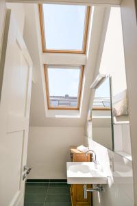 a bathroom with a sink and a skylight at Ostsee - Appartement Nr 25 "Godetied" im Strand Resort in Heiligenhafen