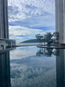a large body of water between two buildings at Borneo Staycation - The Shore in Kota Kinabalu