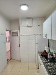 a kitchen with white cabinets and a counter top at Joli appartement en plein centre de Rabat in Rabat