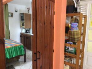 a room with a door open to a room with a kitchen at Philippe & Arlette SMITH in Sainte-Luce