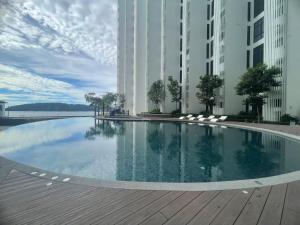 a large swimming pool in the middle of a building at Borneo Staycation - The Shore in Kota Kinabalu
