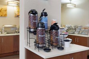 a shelf with several water bottles on a kitchen counter at Comfort Inn & Suites in Wichita