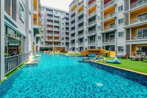 a swimming pool in the middle of an apartment complex at Bauman Residence in Patong Beach