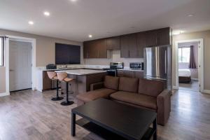 a kitchen and living room with a couch and a table at Super 8 by Wyndham Niagara Falls ON in Niagara Falls