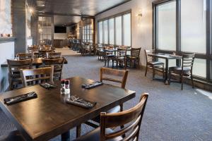 a dining room with wooden tables and chairs at WaterView Casino & Hotel, Trademark Collection by Wyndham in Vicksburg