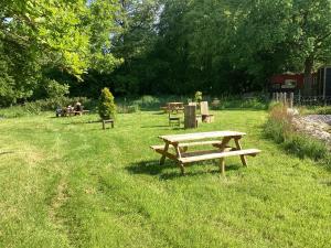 a group of park benches in a grass field at Cabin 4 in Kent