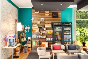 a store with blue walls and chairs in a store at Vienna House Easy by Wyndham Wuppertal in Wuppertal