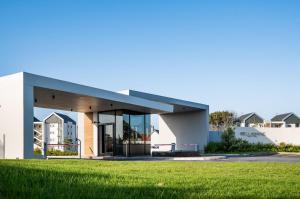 a building with a grass field in front of it at Coastal Elegant At Bellamare in Summerstrand