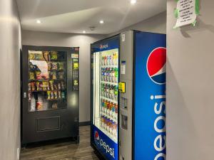 a cocacola soda machine next to a drink cooler at Motel 6 Sault Ste. Marie, ON in Sault Ste. Marie +23 photos