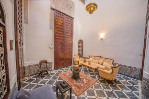 a living room with two couches and a table at Riad Chilling in Fès