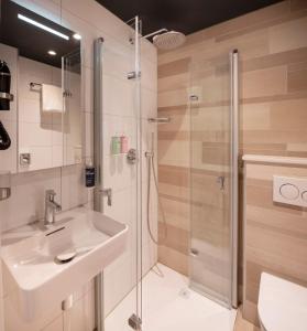 a bathroom with a sink and a shower at Thon Hotel Rotterdam City Centre in Rotterdam