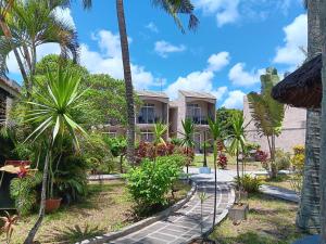 a house on the beach with palm trees at Le Choisy Mauritius in Mont Choisy