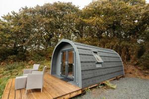 a tiny house sitting on a wooden deck at Cefn Crib Cabins in Machynlleth