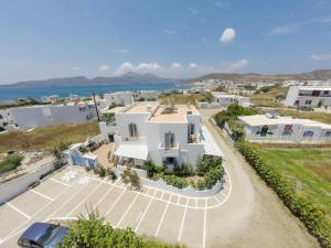 an aerial view of a white house with a parking lot at Aggelos Studios in Adamas