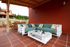 a patio with a couch and a coffee table at Casa Menora Playa de Carnota in Carnota