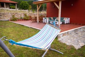 a blue and white hammock in a yard next to a house at Casa Menora Playa de Carnota in Carnota +41 photos