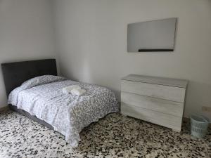 um quarto com uma cama com uma cómoda e um espelho em NIKI HOME em Podenzano