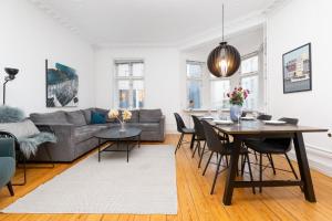 a living room with a table and a couch at Århus bedst placerede lejlighed & udsigt in Aarhus