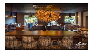 a dining room with a large table and chairs at The Kinmel & Kinspa in Abergele +28 photos