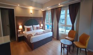a hotel room with a bed and a window at HOTEL CLIFFTON ROYALS in Darjeeling