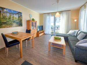 a living room with a couch and a table at Villa Annika - Apt. 08 in Ostseebad Sellin