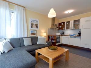 a living room with a couch and a table at Villa Annika - Apt. 08 in Ostseebad Sellin +13 photos