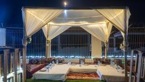 a large table with a white canopy in a room at Sabah Hôtel & Resort in Nouakchott