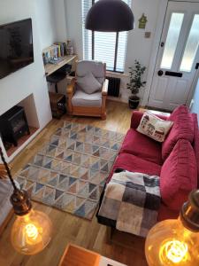 a living room with a couch and a chair at LITTLE HAVEN 1 Bedroom House sought after area in Topsham