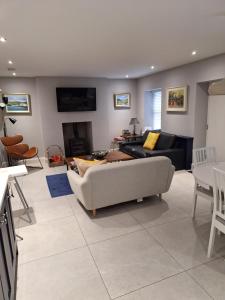 a living room with a couch and a table at Ryan's Cottage in Rostrevor