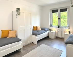 a room with two beds and two windows at Monteurwohnung mit Balkon in Hattingen