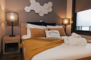 a bedroom with a large white bed with pillows at Lake Resort Suite: Views & Amenities in Lac-Superieur