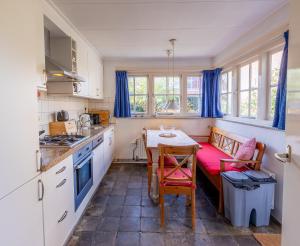 a kitchen with a small table and a couch at Ruime woning in het centrum van Domburg in Domburg +22 photos