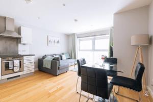 a living room with a couch and a table and chairs at Contemporary 1BD Flat - Bristol City Centre! in Bristol