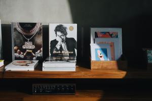 a shelf with books and pictures on it at Surf Motel in Canggu