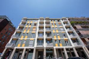 een groot appartementencomplex met gele en grijze ramen bij Casa Giorgia in Milaan