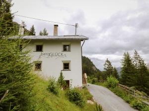 a white building with the word breakfast written on it at Holiday Home bergGLÜCK by Interhome in Spiss