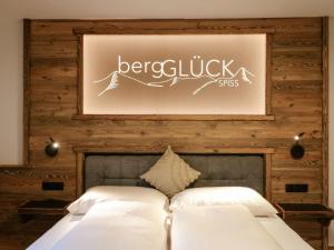 a bedroom with a bed and a picture on the wall at Holiday Home bergGLÜCK by Interhome in Spiss