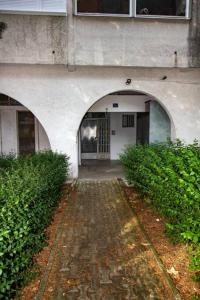 a building with two archways with a door in it at Milan apartment in Bar