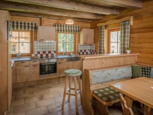 a kitchen with wooden cabinets and a wooden table at Holiday Home Holzknecht by Interhome in Pichl