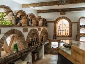a kitchen with a bunch of wine bottles on the wall at Holiday Home Hirtabua by Interhome in Pichl